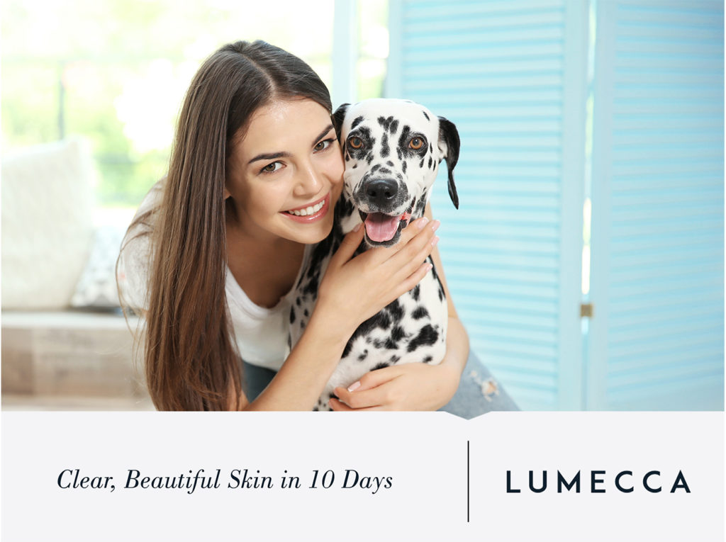 Woman Smiling with a dog - Lumecca logo - Clear, beautiful skin in 10 days